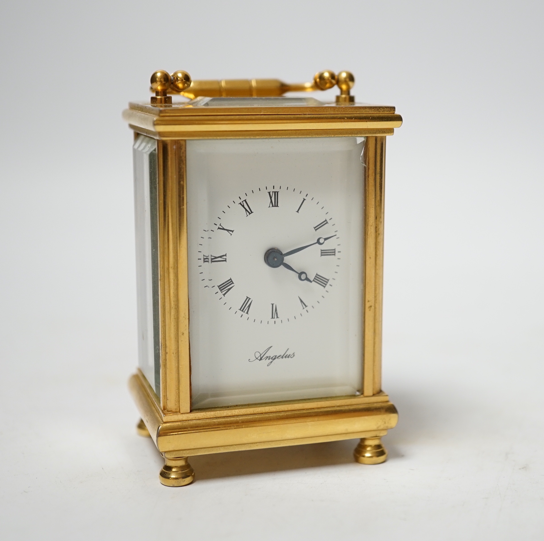 An Angelus miniature brass cased carriage clock with key, 9cm